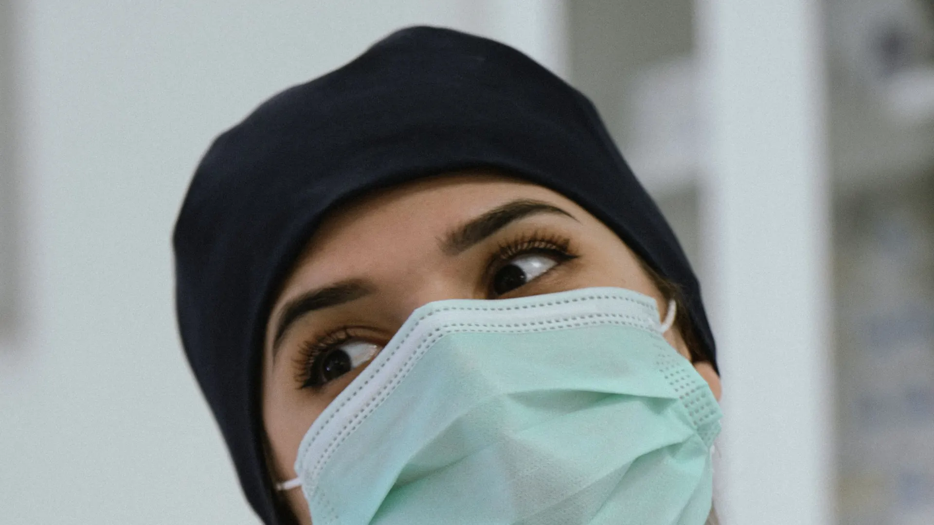 Healthcare professional wearing a face mask and scrubs