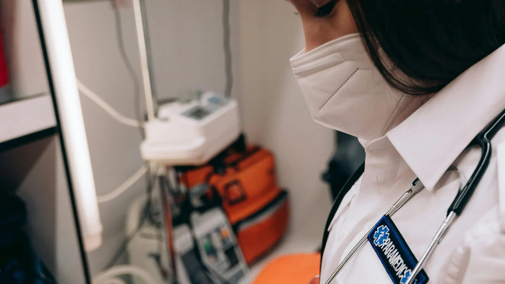 Paramedic with a stethoscope preparing medical equipment