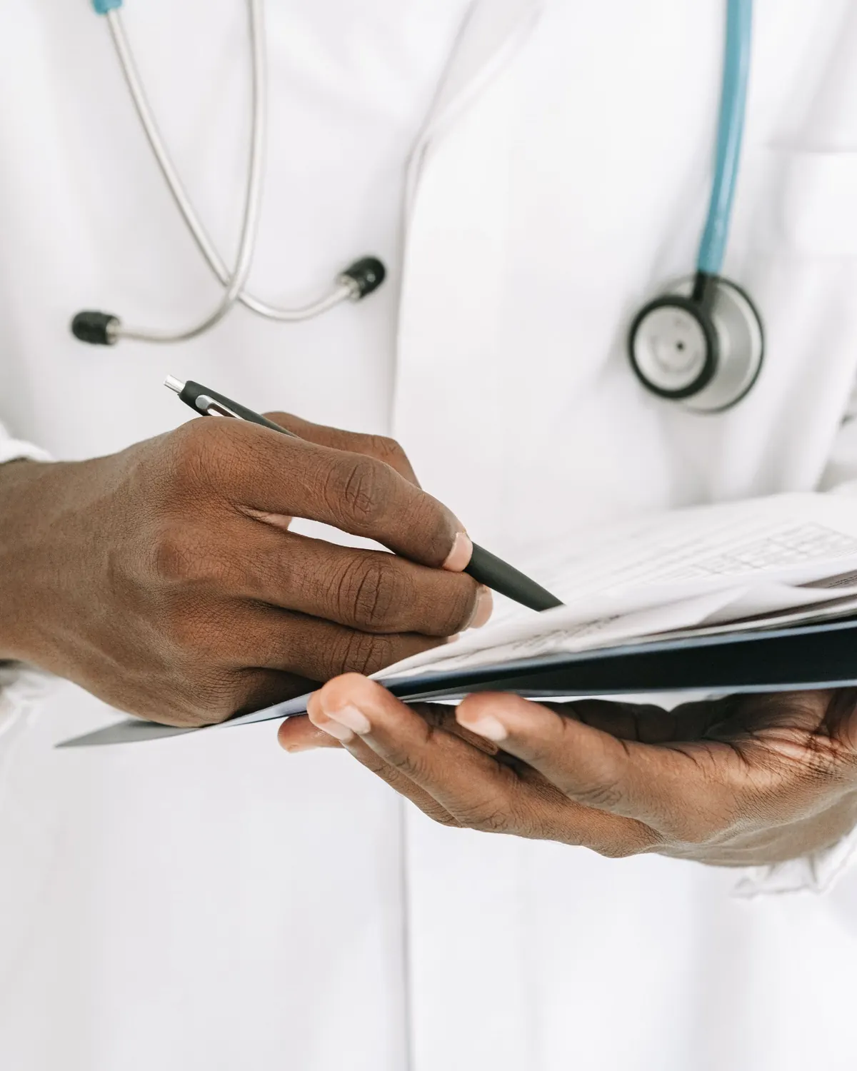 Healthcare professional writing care notes